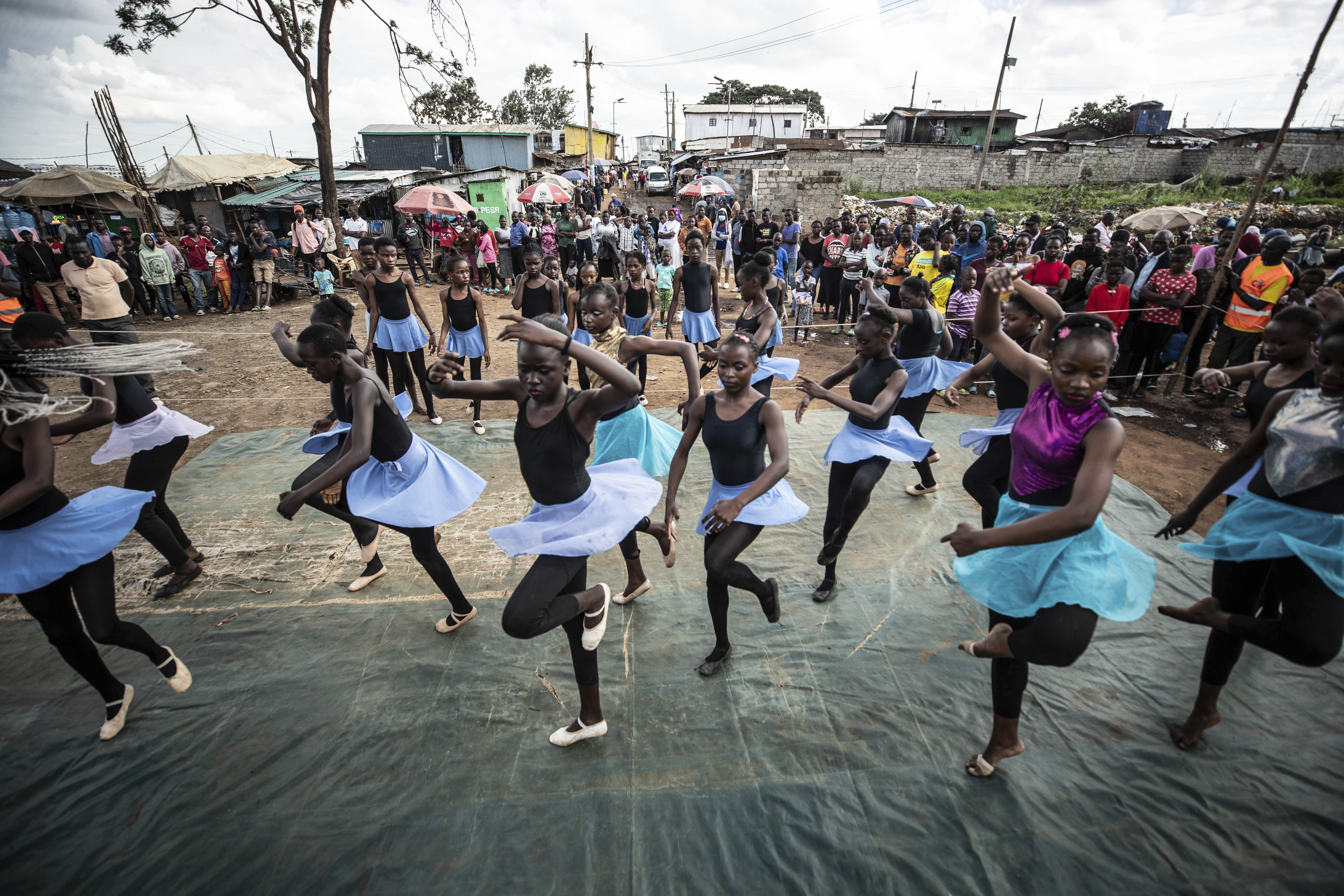 Young dancers practice by the Kenya - Uganda railway line