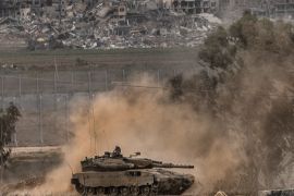 An Israeli army tank moves near the Gaza Strip border, in southern Israel, Saturday, Dec. 23