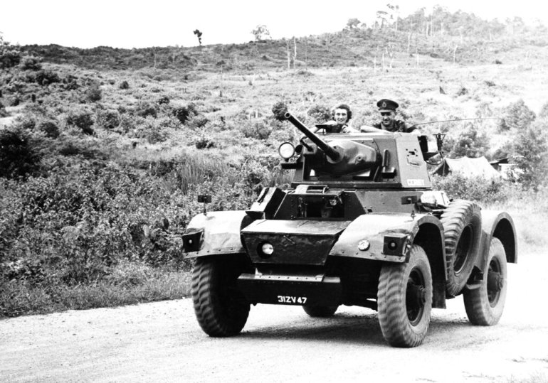 Gen. Sir Gerald Templer and his wife enjoy the countryside on a tour of Kedah in Malayan states, on June 1, 1952. To take a drive in the country is risky business in Malaya these days, so the Malayan High Commissioner used his armored car as a safety measure. (AP photo)