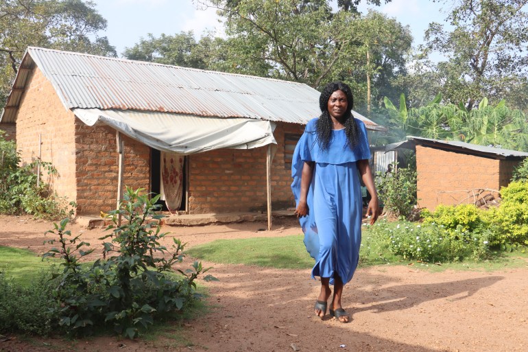 A photo of Blessing’s mother Victorine Ndifon Atop standing in the garden in front of her house.