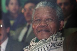 South African anti-apartheid leader and African National Congress member Nelson Mandela (C), wearing a keffiyeh, attends a meeting organised in his honour by the National Union of Algerian Youths, May 18, 1990, in Algiers [Abdelhak Senna/AFP]