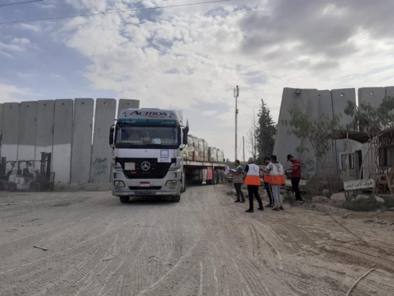 Palestinian Red Crescent team receives a humanitarian aid truck at a location given as the Rafah border crossing between Egypt and the Gaza Strip, in this handout picture released on December 2, 2023. [Palestine Red Crescent Society/Handout via REUTERS]
