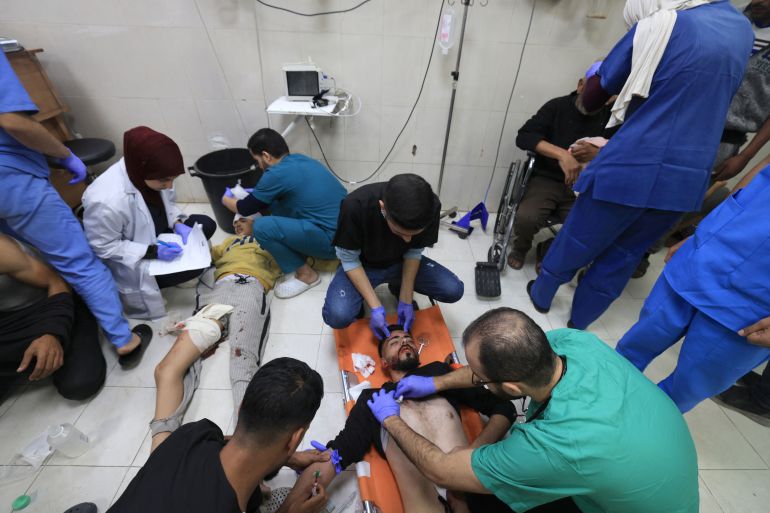 Medics treat Palestinians injured in Israeli bombardment, at Nasser hospital in Khan Younis in the southern Gaza Strip on December 17, 2023, [Mahmud HAMS / AFP]