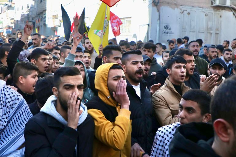 Protesters and mourners at the funeral procession of Ahmed Muhammad Yaghi, 17, and Ibrahim Majed Al-Titi, 31, killed in an Israeli attack on al-Fawwar refugee camp on December 26, 2023