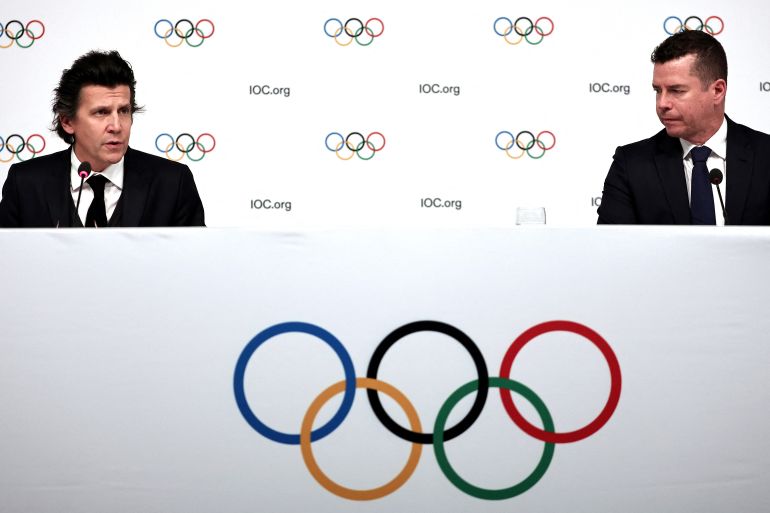 Olympic Games Executive Director Christophe Dubi (L) and Olympic Games Sports Director Kit McConnell answer journalists' questions during a press conference after an International Olympic Committee (IOC) Executive Board committee meeting in Paris, on November 29, 2023. [FRANCK FIFE / AFP]