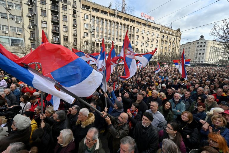 Protesters wave Serbian flags as they attend a rally of "ProGlas", a Serbian pro-democracy movement, to protest against alleged electoral fraud, in Belgrade, on December 30, 2023. [Andrej ISAKOVIC / AFP]