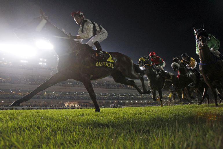 Dan Excel, a horse ridden by jockey Tommy Berry, heads to victory in a night race at the Singapore Turf Club