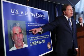 Geoffrey Berman, United States Attorney for the Southern District of New York, points to a photograph of Jeffrey Epstein as he announces the financier's charges of sex trafficking of minors and conspiracy to commit sex trafficking of minors.