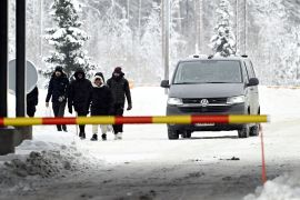 Migrants arrive at the Vaalimaa border checkpoint between Finland and Russia in Virolahti, Finland