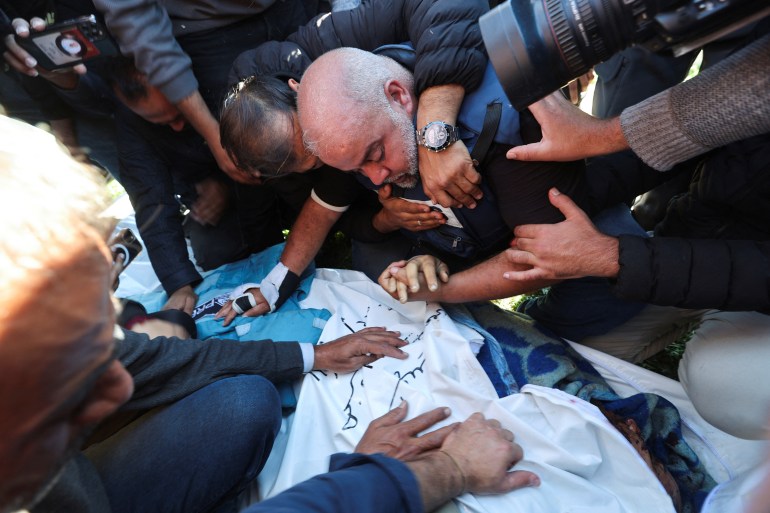 Al Jazeera journalist Wael Al-Dahdouh reacts as he attends the funeral of his son, Palestinian journalist Hamza Al-Dahdouh
