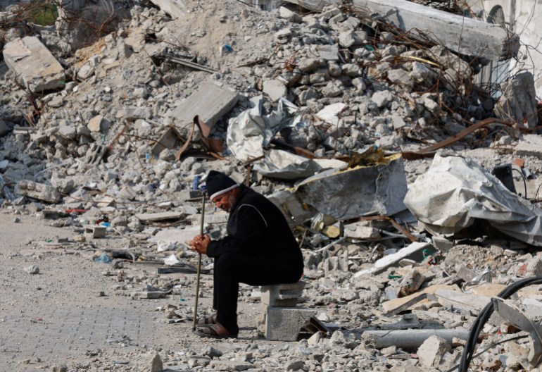 A Palestinian man sits near the rubble of a house destroyed in an Israeli strike amid the ongoing conflict between Israel and the Palestinian Islamist group Hamas, in Rafah in the southern Gaza Strip, January 9, 2024. REUTERS/Mohammed Salem