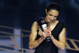FC Barcelona's Aitana Bonmati holds a trophy on stage after winning the best women's player of 2023 during the awards ceremony