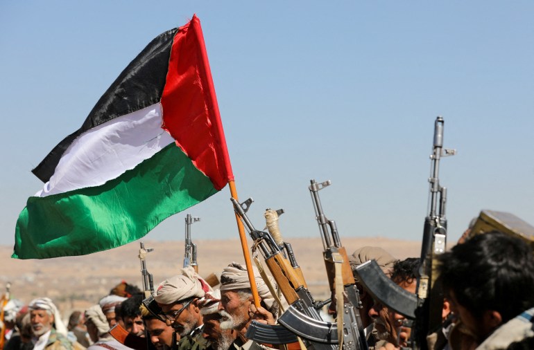 supporters of Yemen's Houthis wave a Palestinian flag