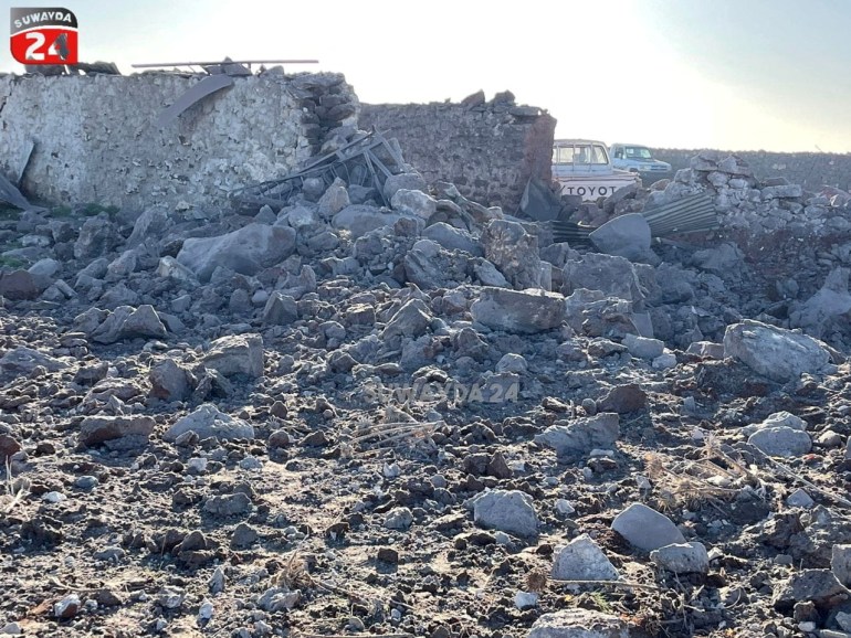 A TV screenshot of a pile of rubble after a January 18 air strike in southern Syria.