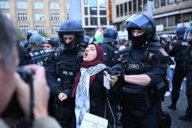 Riot police detain a demonstrator during a pro-Palestinian rally in Frankfurt on October 14, 2023 [File: Kirill Kudryavtsev/AFP]
