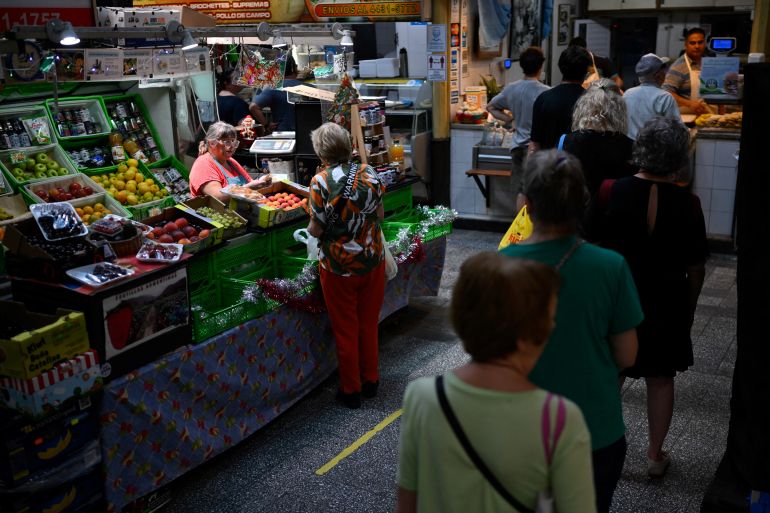 People line up at a market in Buenos Aires on January 5, 2024