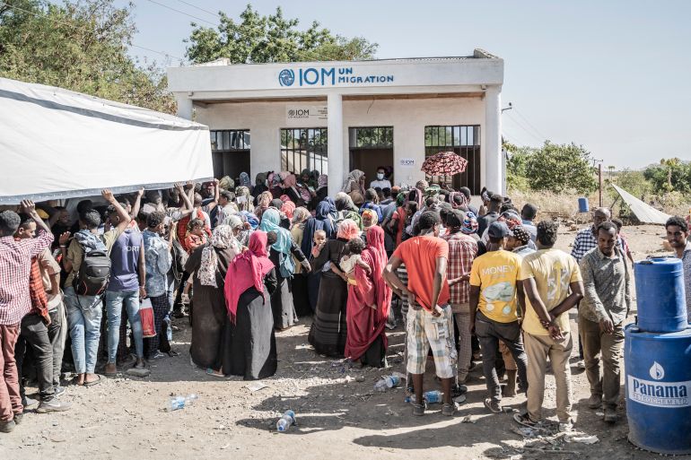 Refugees who crossed from Sudan to Ethiopia wait in line to register at IOM (International organization for Migration) in Metema