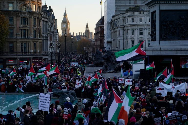 Protester hold flags and placards as they take part in a pro-Palestinian demonstration in Trafalgar Square in London