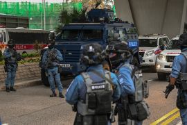 Armed police and an armoured vehicle outside the court where the Jimmy Lai trial is taking place