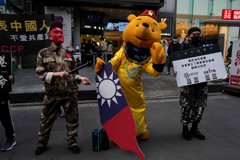 Taiwanese people protest against the communist party. One is dressed as Winnie the Pooh a representation of Chinese president Xi Jinping