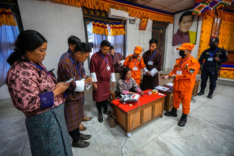 Polling officials unseal an electronic voting machine to count votes after general election in Deothang, Bhutan, Tuesday, Jan. 9, 2024. Voters in Bhutan, a landlocked country in the eastern Himalayan mountain range with a population of around 800,000 people, are casting ballots to elect a new Parliament. (AP Photo/Anupam Nath)