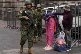 A soldier patrols the streets of Quito