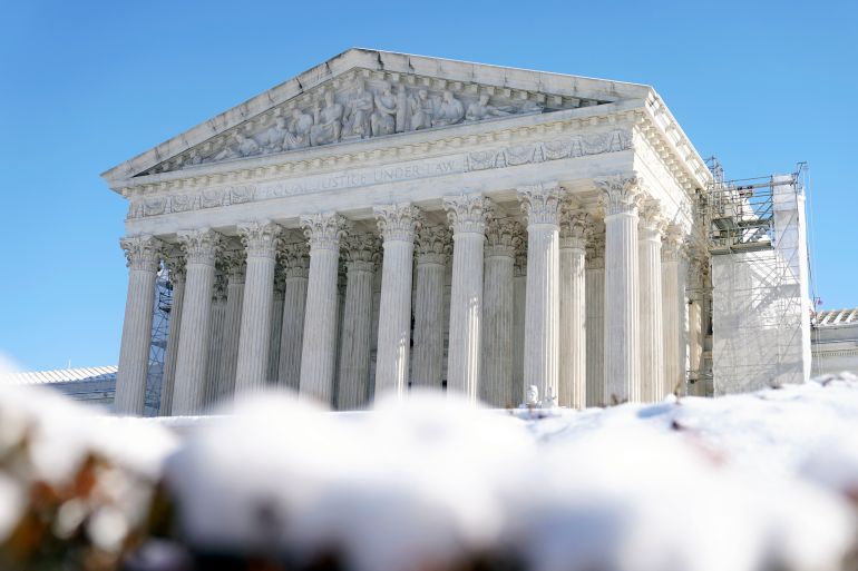 A picture of the columned entrance of the US Supreme Court, surrounded by banks of snow.