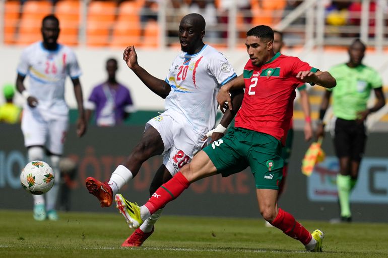 DR Congo's Yoane Wissa and Morocco's Achraf Hakimi, from left, challenge for the ball during the African Cup of Nations Group F soccer match between Morocco and DR Congo, at the Laurent Pokou stadium in San Pedro, Ivory Coast, Sunday, Jan. 21, 2024. (AP Photo/Themba Hadebe)