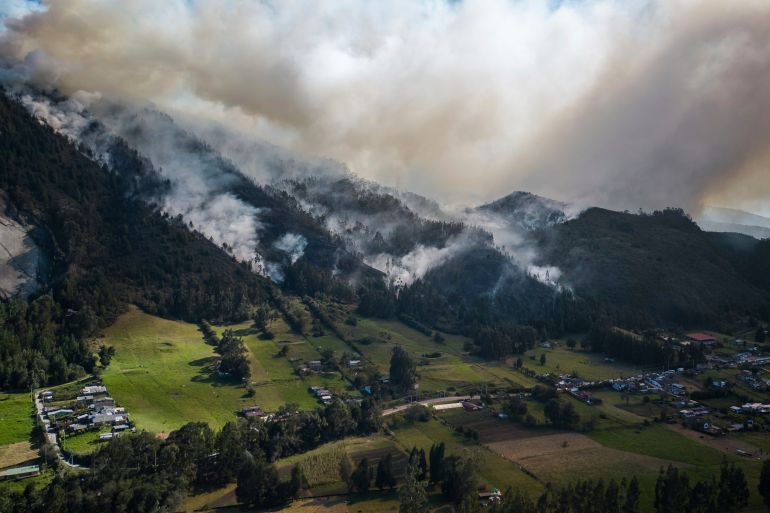 Smoke rises from a fire burning on the slopes of the mountains surrounding Nemocon, north of Bogota