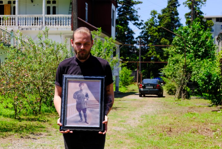 Nika Kuznetsov, Hasan's great-grandson, holds the only photo that the family has of Hasan