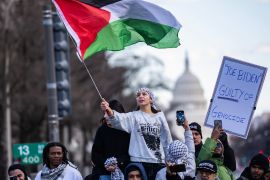 a woman waves a Palestinian flag