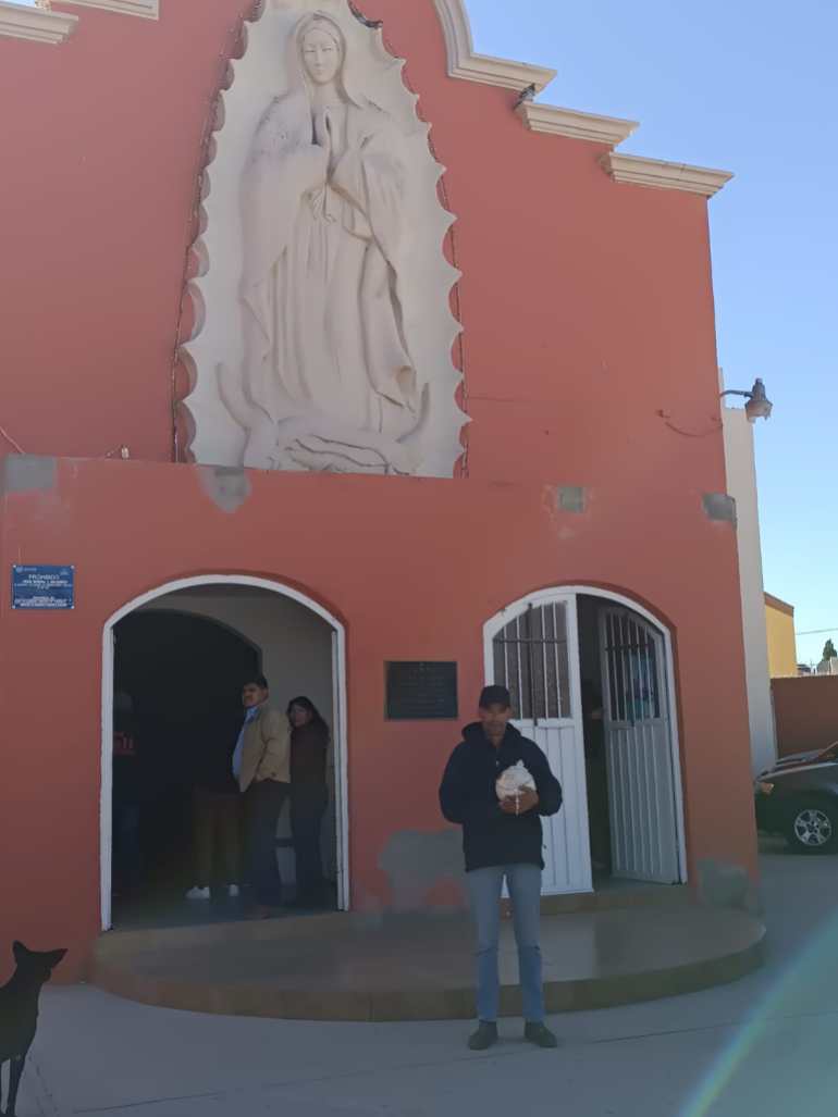 Victor Hidalgo Lopez holds a small round urn carrying Emiliannys's remains outside a church in Chihuaha, Mexico