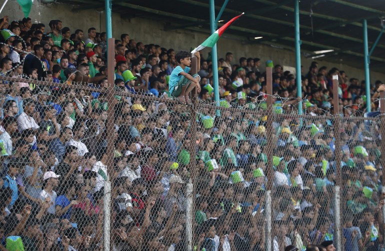 Palestinian spectators watch the first leg of Palestine Cup final soccer match between Gaza Strip's Shejaia and Hebron's Al-Ahly at al-Yarmouk stadium in Gaza City August 6, 2015. A Palestinian team from the Gaza Strip hosted West Bank opposition for the first time in 15 years on Thursday after Israel gave the visitors permission to cross its territory for the clash between the two lands' respective cup holders. The Gaza Strip's Shejaia and Al-Ahly from Hebron in the Israeli-occupied West Bank played in a fixture that appeared in doubt before the permit granted by Israel, whose territory separates Gaza and the West Bank. REUTERS/Suhaib Salem
