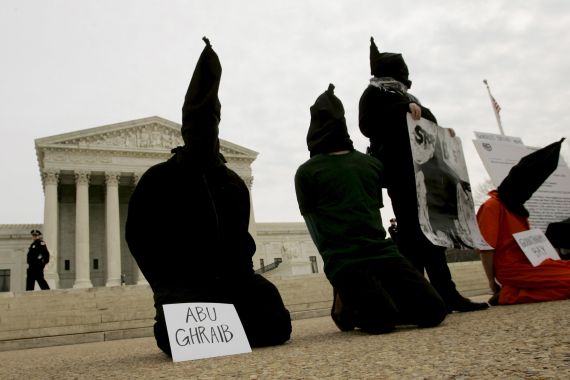 District of Columbia Anti-War Network activists take part in a demonstration to oppose "American violations of international human rights" at the Abu Ghraib prison in Iraq by U.S. military personnel in front of the U.S. Supreme Court in this February 9, 2005 file photo. Nearly two-thirds of Americans believe torture can be justified to extract information from suspected terrorists, according to a Reuters/Ipsos poll, a level of support similar to that seen in countries like Nigeria where militant attacks are common. To match Exclusive USA-ELECTION/TORTURE REUTERS/Larry Downing/Files