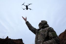 A Ukrainian soldier catches a drone while testing it near Bakhmut in eastern Ukraine on November 25, 2022 [File: Reuters/Leah Millis]
