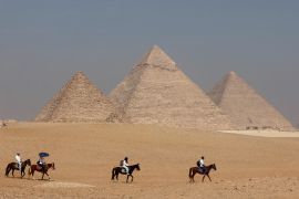 Tourists ride horses in front of the Great Pyramid of Giza, on the outskirts of Cairo, on October 26, 2023. Egypt&#039;s tourism revenue could drop by 30 percent in 2024 because of Israel&#039;s continuing war on Gaza [Mohamed Abd El Ghany/ Reuters]