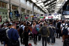 Travellers on the concourse wait for their train at Gare de Lyon train station in Paris, France