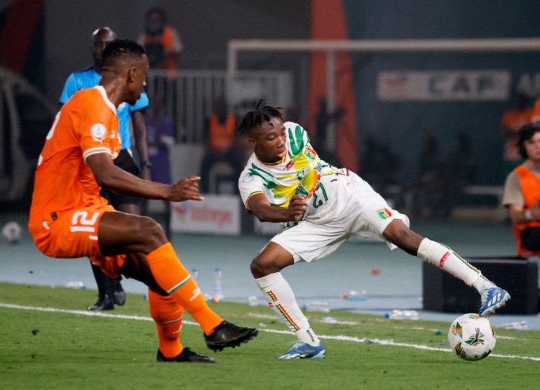 Mali's Nene Dorgeles in action with Ivory Coast's Willy Boly