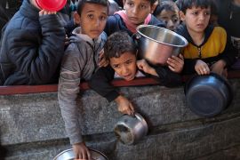 Palestinian children waiting for food cooked by a charity amid widespread hunger, as Israel&#039;s war on Gaza continues, in Rafah on February 5, 2024 [Ibraheem Abu Mustafa/Reuters]