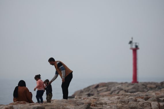 A family is pictured near the port in Shengjin, Albania