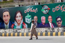 A billboard displays photos of politician Bilawal Bhutto Zardari, far left, next to his sister Asifa Bhutto Zardari a day after a general election in Pakistan [Akhtar Soomro/Reuters]