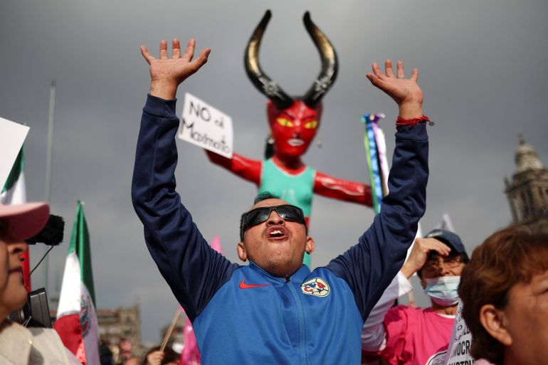 A demonstrator gestures as Mexican opposition groups march against government