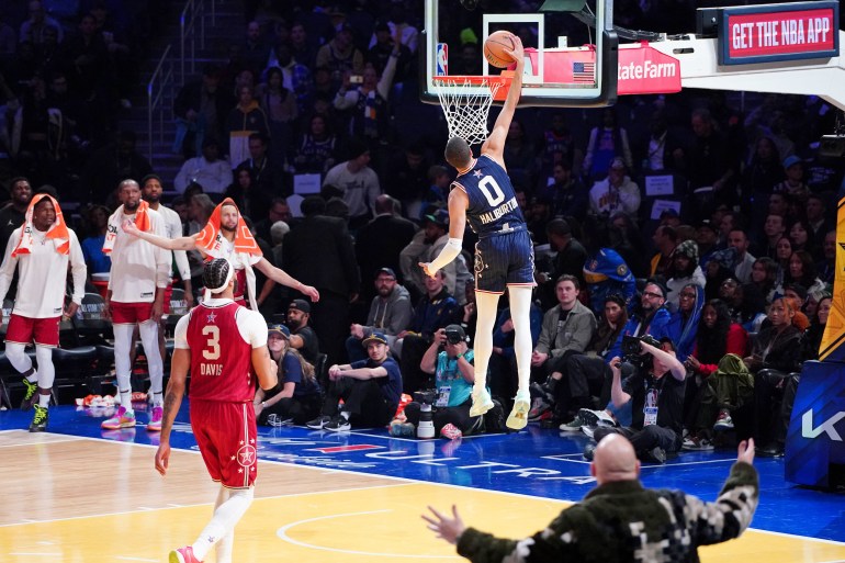 Feb 18, 2024; Indianapolis, Indiana, USA; Eastern Conference guard Damian Lillard (0) of the Milwaukee Bucks dunks the ball during the second half of the 73rd NBA All Star game at Gainbridge Fieldhouse. Mandatory Credit: Kyle Terada-USA TODAY Sports