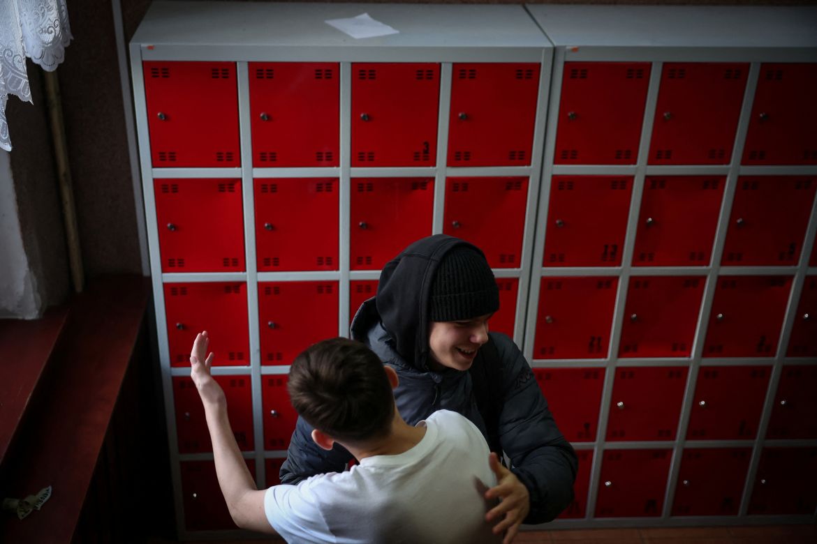 Andrii Nonka, 15, from Kharkiv, greets a fellow student after he finishes lessons at a school in Gdansk, Poland, February 21