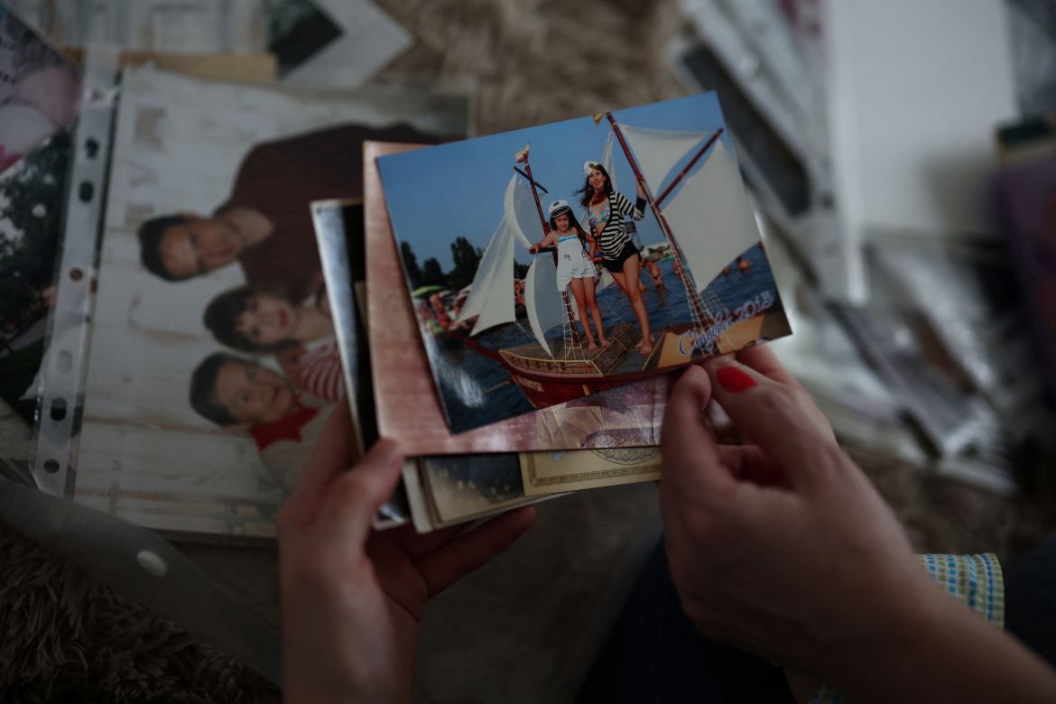 Marharyta Chykalova, 16, from Kherson, and her mother Tetiana Chykalova, view photos and memorabilia at their apartment in Gdynia, Poland, February 17,