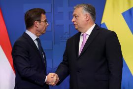 Swedish Prime Minister Ulf Kristersson and Hungarian Prime Minister Viktor Orban shake hands at a joint news conference in Budapest, Hungary, February 23, 2024 [Bernadett Szabo/Reuters]