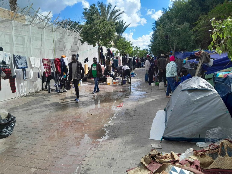 The passage where tens of refugees are camped. It's crowded and a leak makes the ground wet