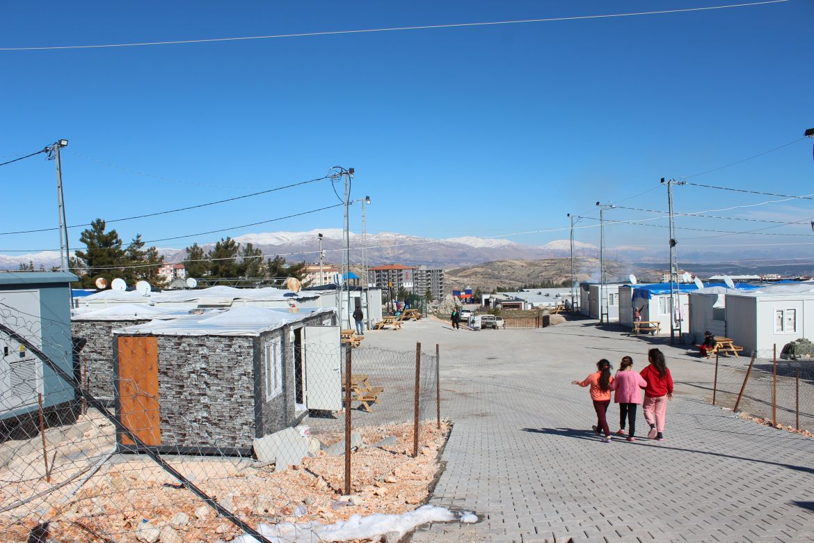 A vista of the mountains offers some relief from the narrow streets and tiny containers.