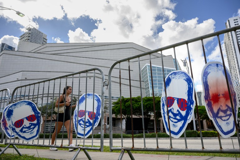 Cut-outs of the "Dark Brandon" internet meme are displayed across from the Adrienne Arsht Center for the Performing Arts, the venue for the third Republican presidential primary debate in Miami