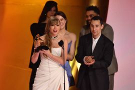 Taylor Swift accepting her Emmy. She looks happy.